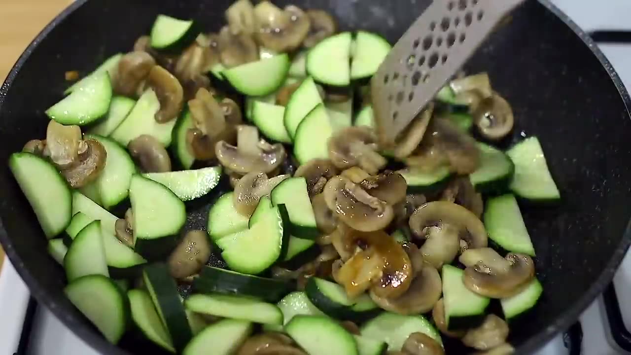 Fried potatoes with mushrooms and zucchini in a pan. An easy and delicious dinner!