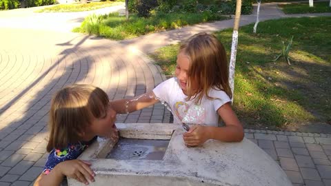 Water from Street Drinking Fountain and his older sister helps