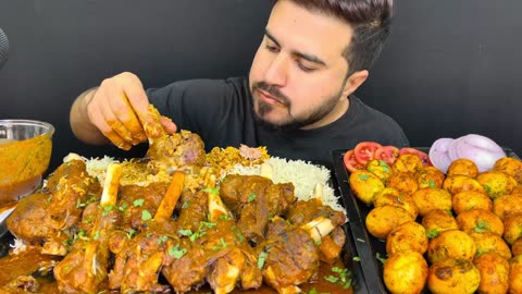Eating spicy mutton leg curry and mutton curry with rice