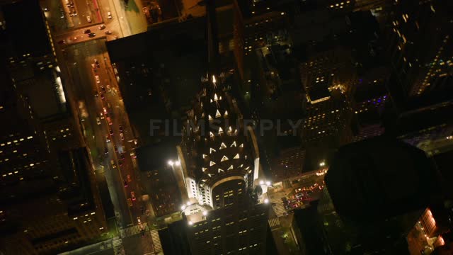 A tall tower in the city illuminates the night sky