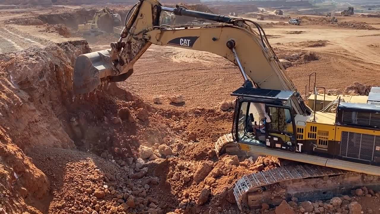 Caterpillar 365C Excavator Loading Trucks