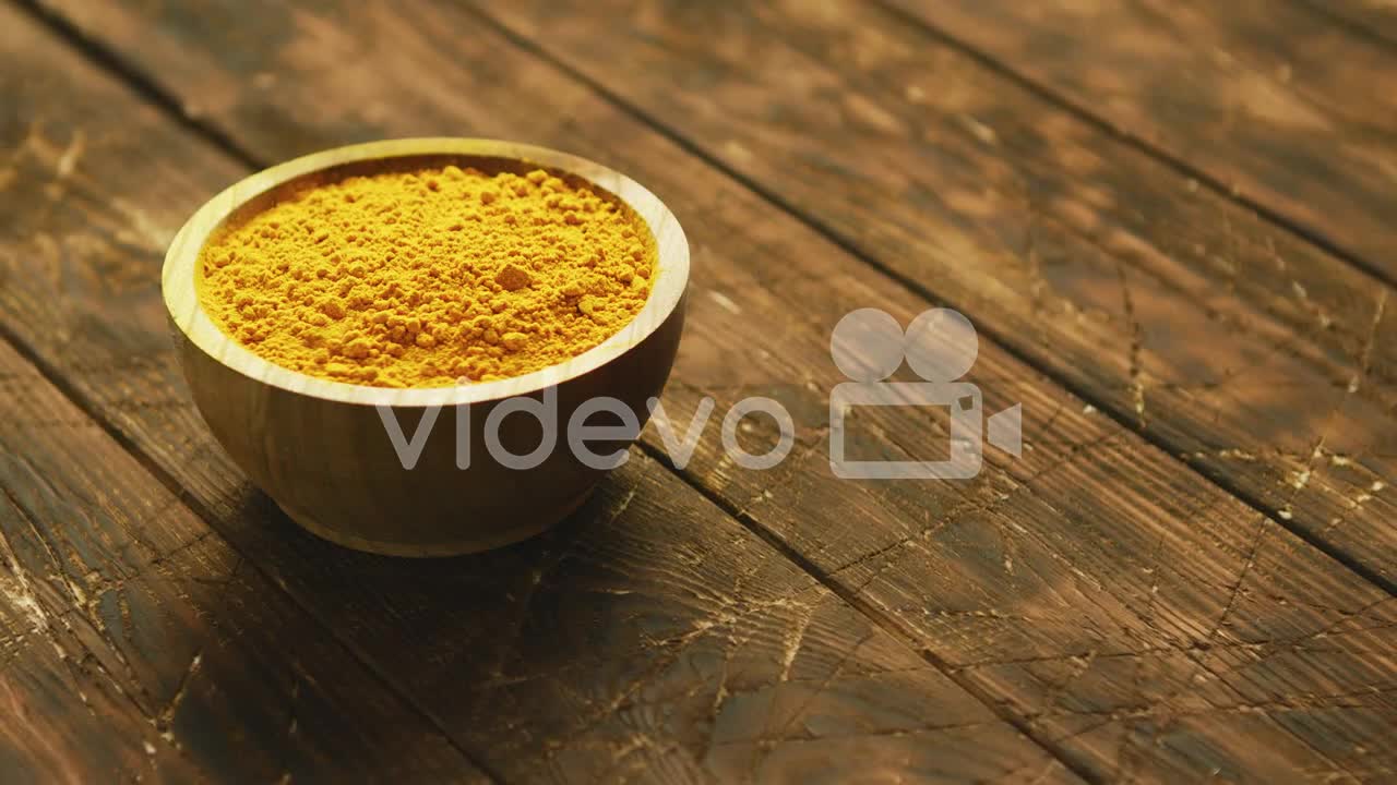 Small bowl of orange turmeric spice