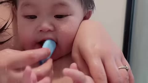 Brush your child's teeth while bathing