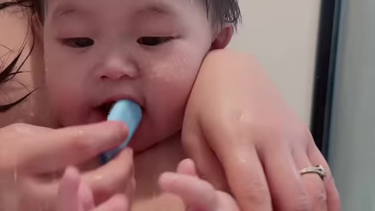 Brush your child's teeth while bathing