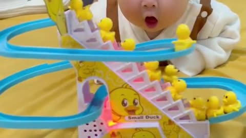 baby's funny moments seeing moving toys walking