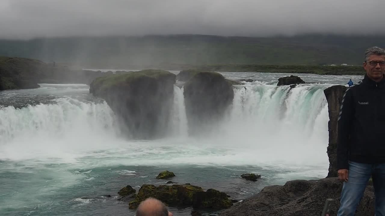 Man Having A Photo Taken Near A Waterfalls