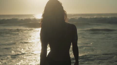 Silhouette Of A Woman's Hands Moving/Woman Walking Into The Ocean