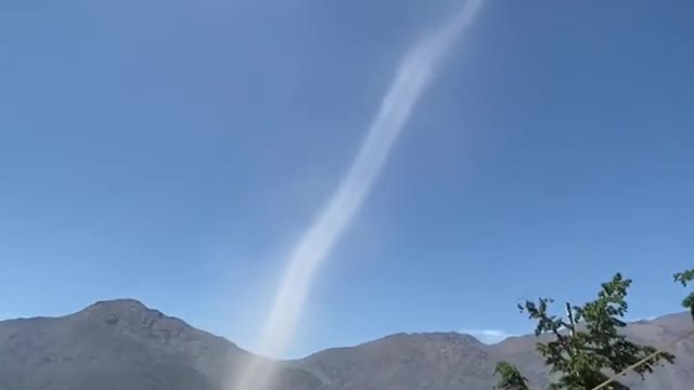 Person Witnesses Dust Devil Formation While Hiking in Mountains of Chile