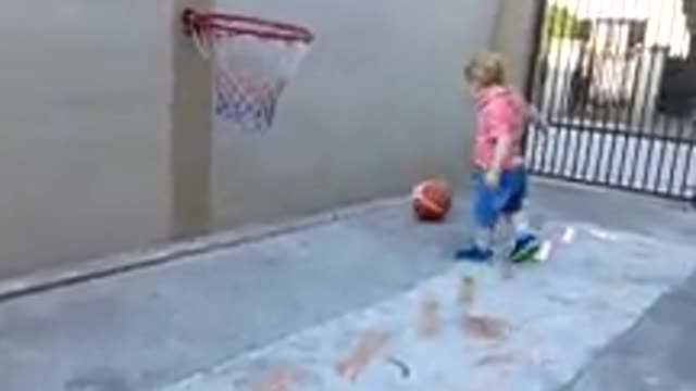 Baby playing basketball