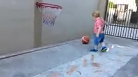 Baby playing basketball