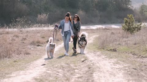 two women and tow dogs