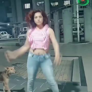 GIRL DANCES WHILE A DOG...