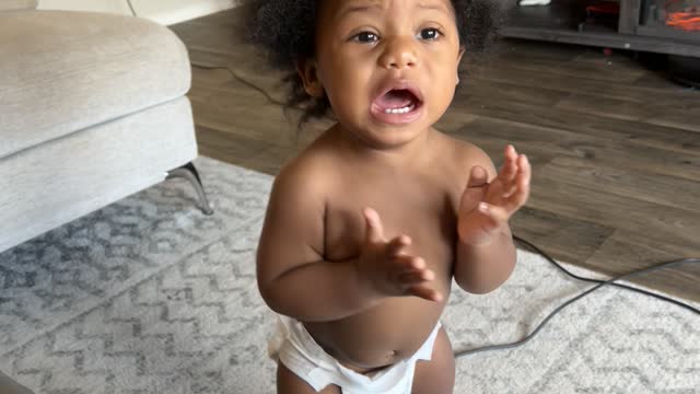 Baby Playing with Vacuum Puts Hose to Face