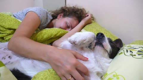 Woman with Dog Laying on Bed before Sleep