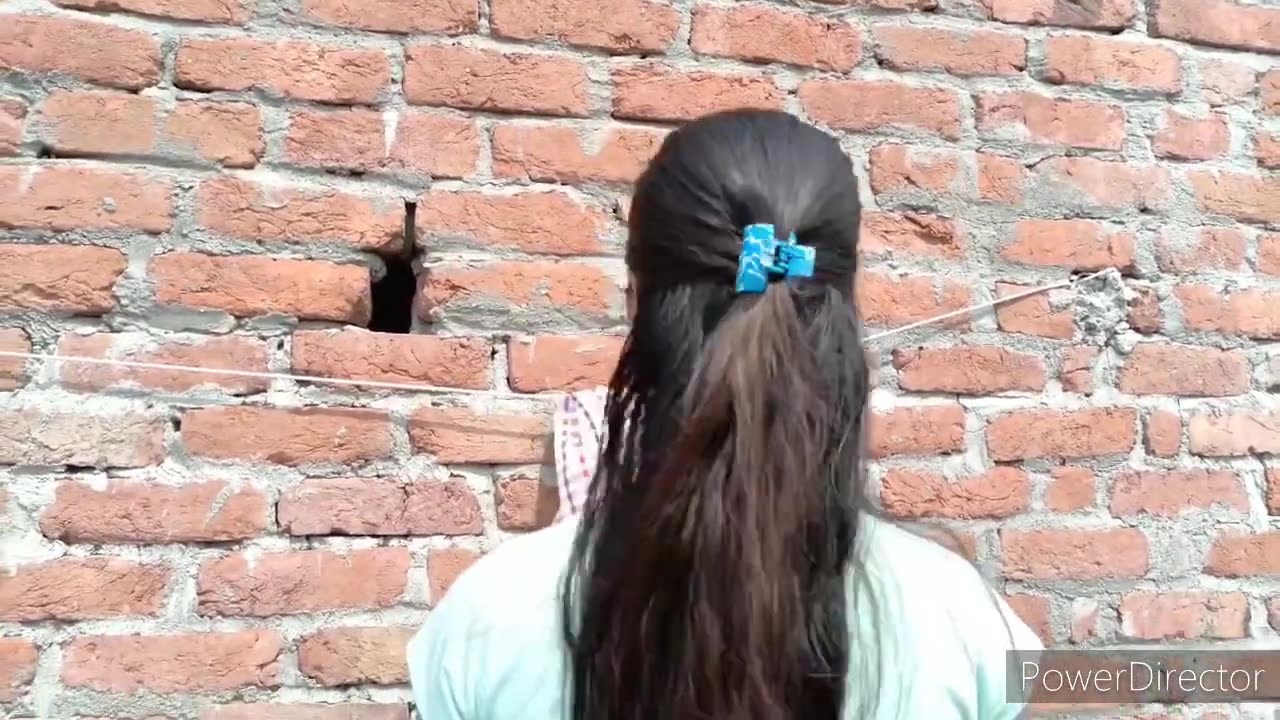 Beautiful girl drying her hair in traditional towel style in sunlight with her soft_shiny-silky hair