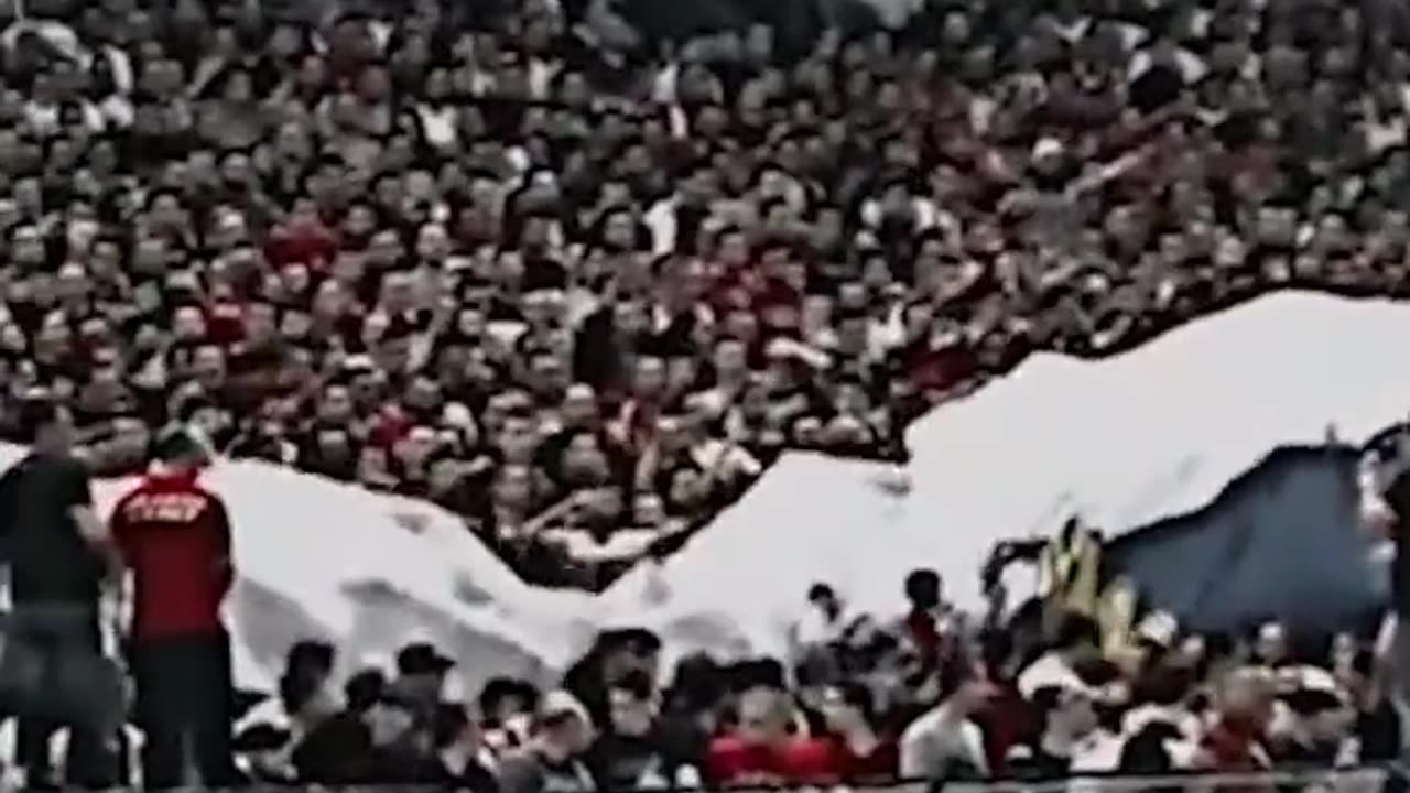 Serbian football fans stretch a huge flag of Russia at the match with Ukraine