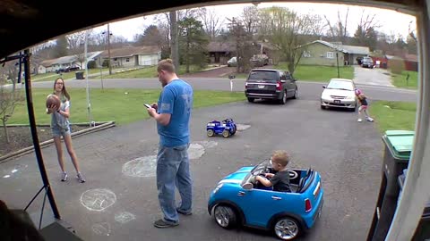 Child Sneaks Up on Dad with Toy Car