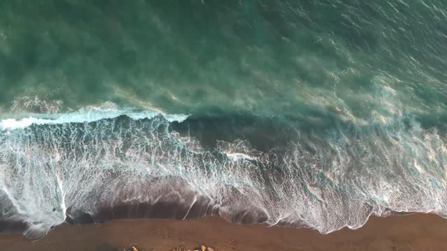 beach from above - waves splashing on beach