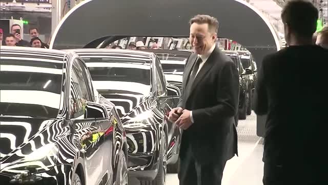 Dancing Musk hands out first Teslas from new factory