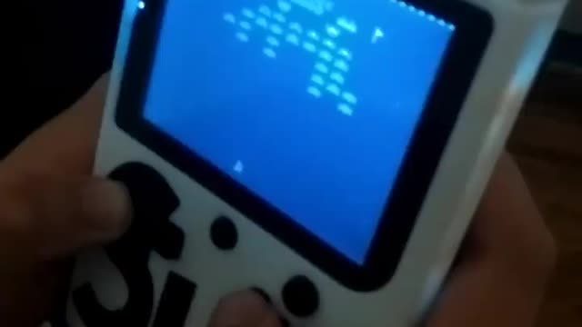 "Game boy" style retro-console with Galaxian game...