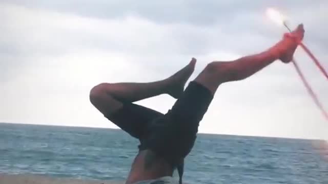 Guy Shows Cool Moves While Spinning Hula Hoop With Fire At Beach