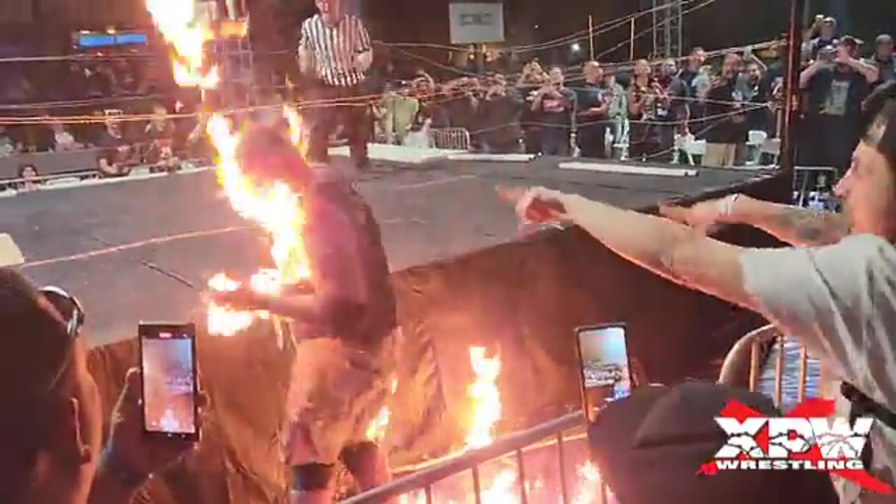 pro wrestler sets himself on fire during stunt.