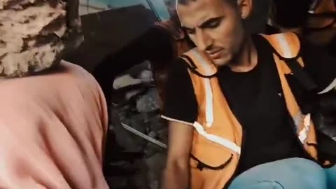 Palestinian mother searching for her daughter's shoes amongst the shoes of the martyrs