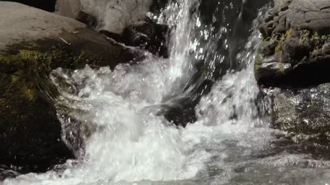 Water crashes among rocks