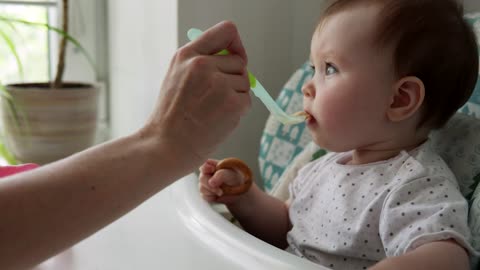 Mother feeding her young baby