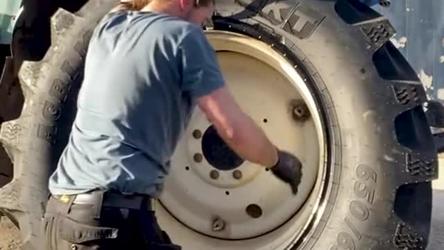 @thetyrewarrior uses incredible strength to fit tractor tires in the best way possible