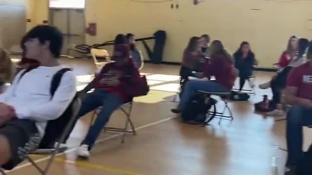 Banished students maskless in the gym. *See description*