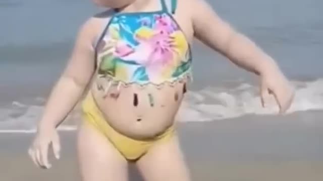 Little cute baby dancing in Sea beach looking very pretty