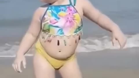 Little cute baby dancing in Sea beach looking very pretty