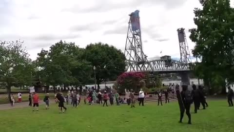 Antifa throwing explosives near children