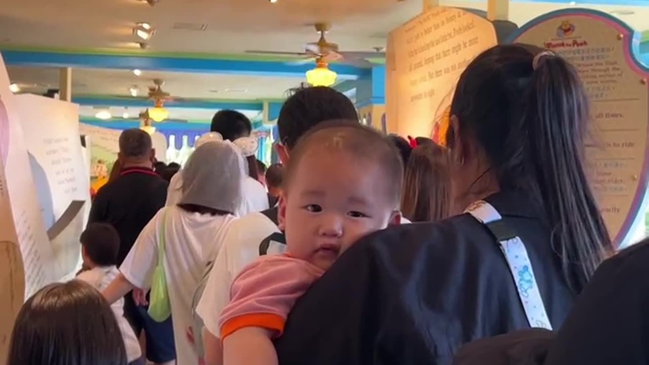 Disneyland Visitor Makes Funny Faces at a Baby