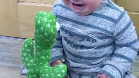 baby playing with cactus