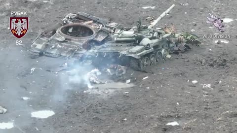 Russians Search for Cover Under Destroyed Vehicles