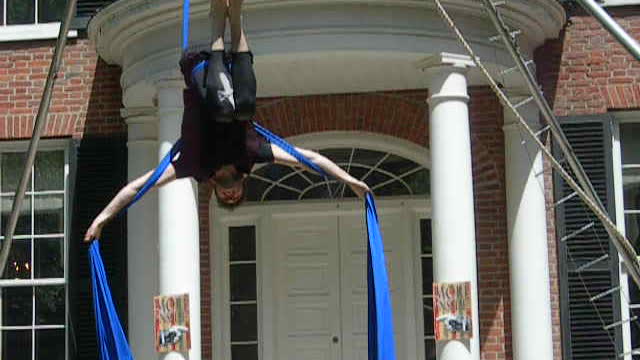 Man performs aerial silks routine