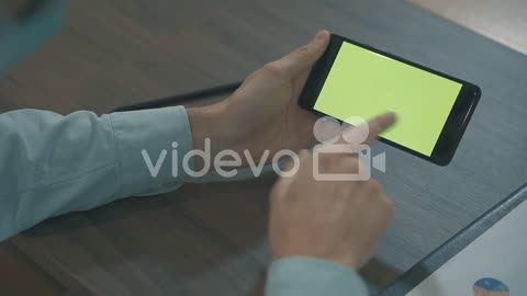 Close Up Of Hands Using A Green Screen Smartphone