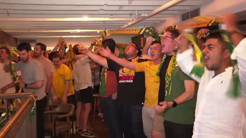 Australia fans celebrate their team's victory against Tunisia in the World Cup.