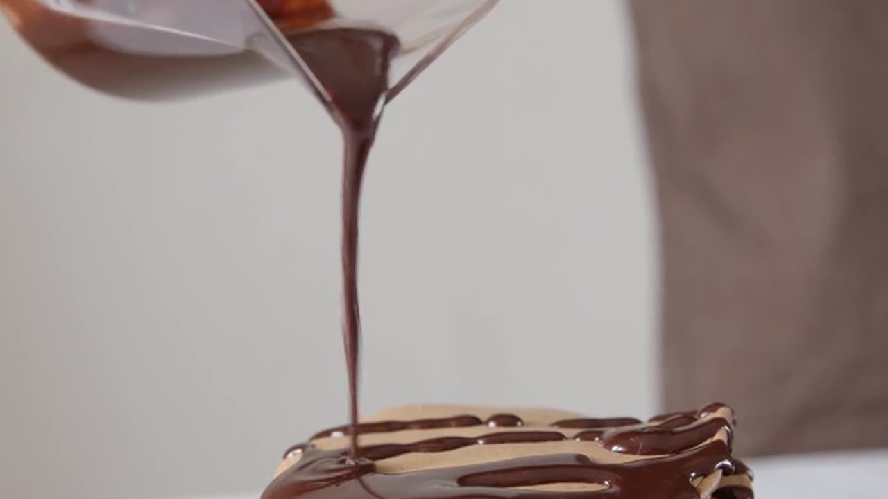 Pouring Chocolate Syrup on Top of Pancakes