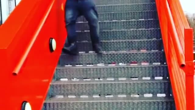 Blue jacket boy slips down stairs