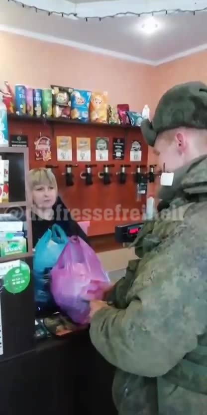 Russian soldier stores in a Ukrainian store. When he wants to pay, the woman gives up the money