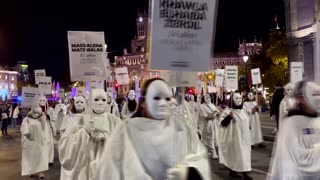 Masked marchers in Madrid denounce violence against women