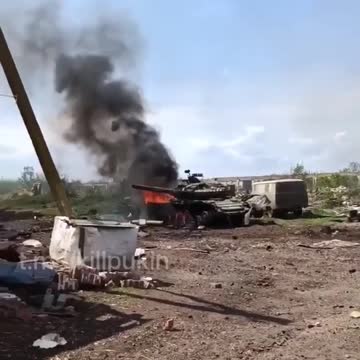 A Russian soldier films from a trench as artillery fire is incoming