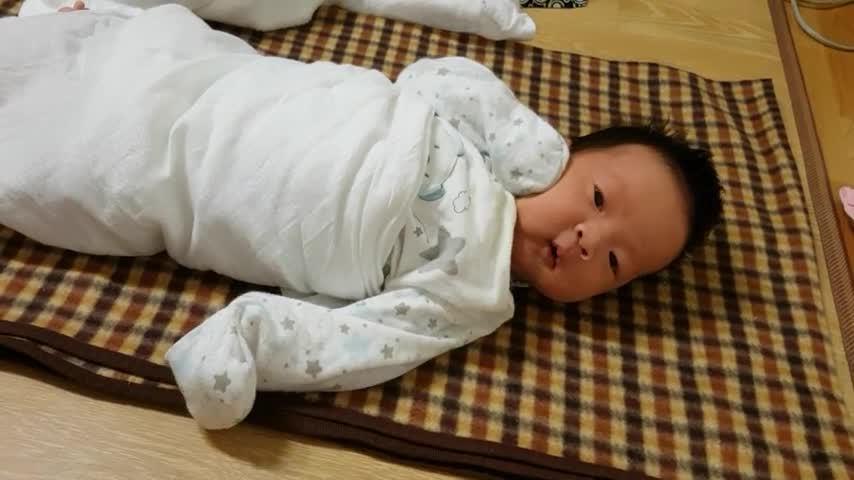Cute baby moving while lying still.