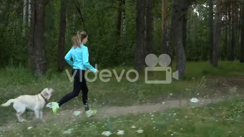 young girl runs with her dog