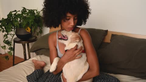 A Woman Hugging and Petting her Dog