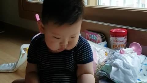 This is a video of a happy baby playing with toys.