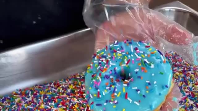Glazed Donut with rainbow sprinkles. Do you want a bite From Friendly Donuts in Orange.